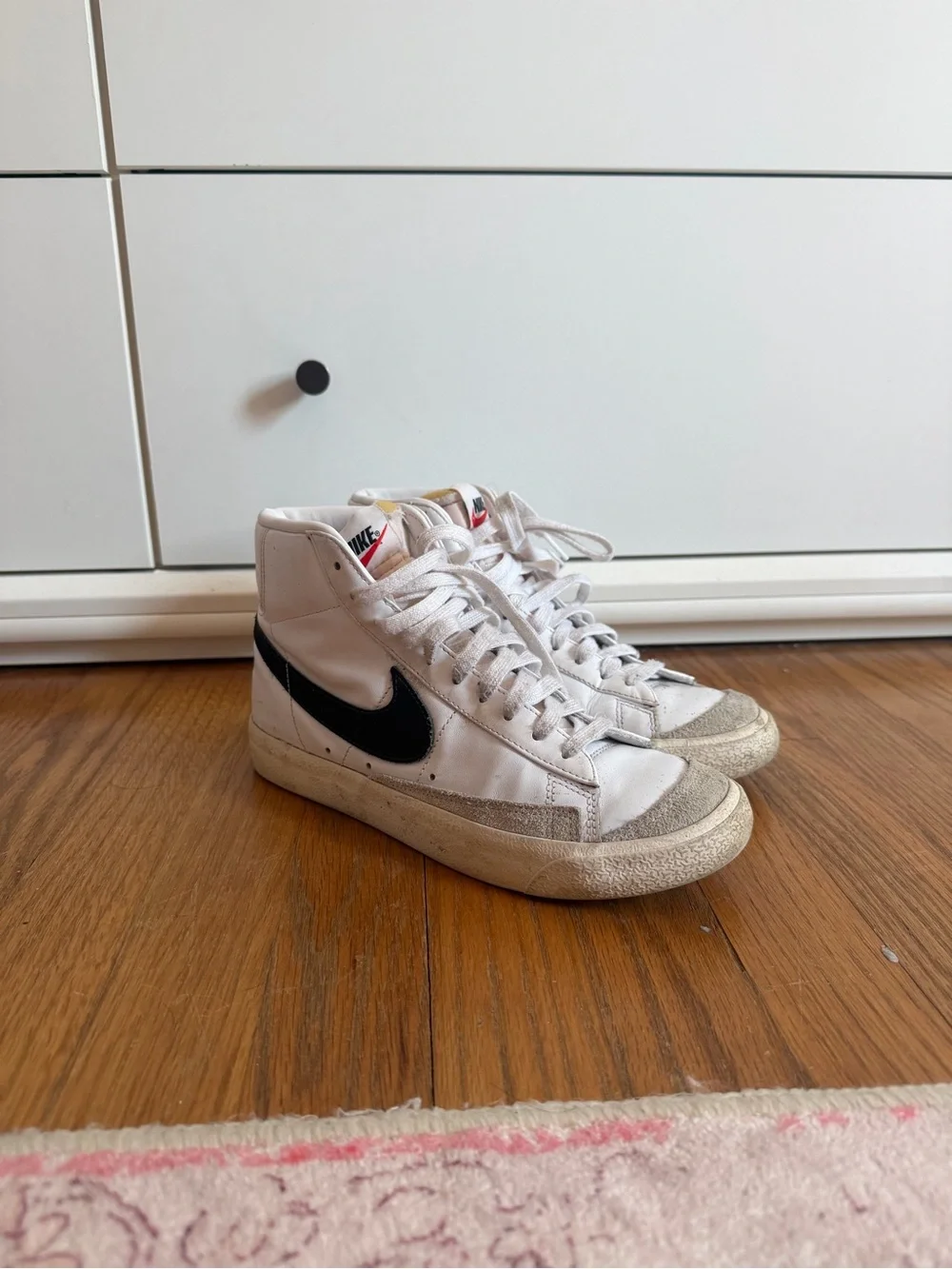 Nike White High-Top Sneakers with Black Swoosh